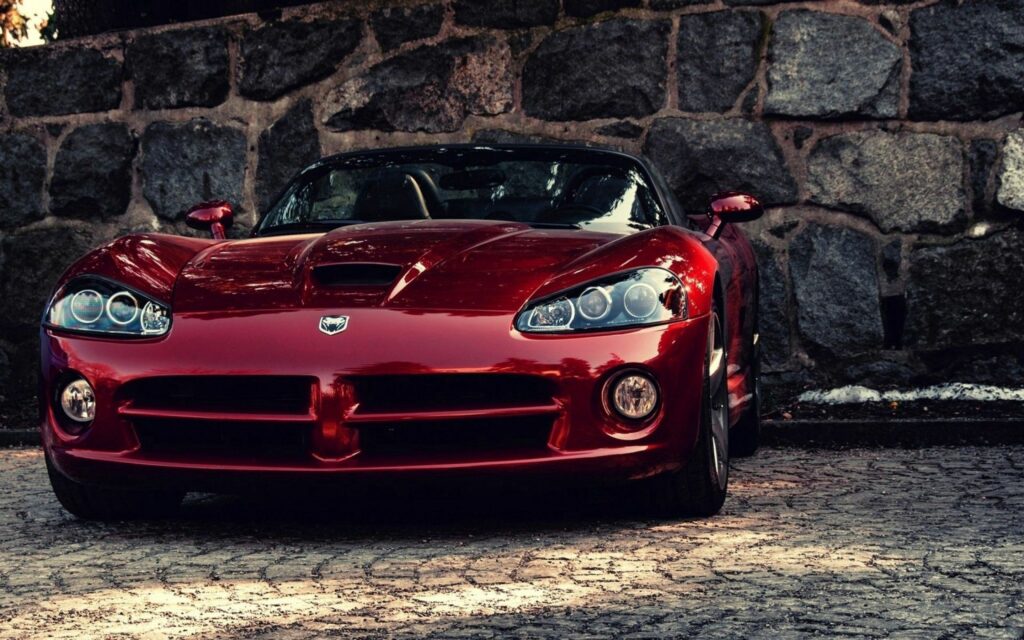 Red Dodge Viper Sports Car Wallpaper on Rugged Stone Background