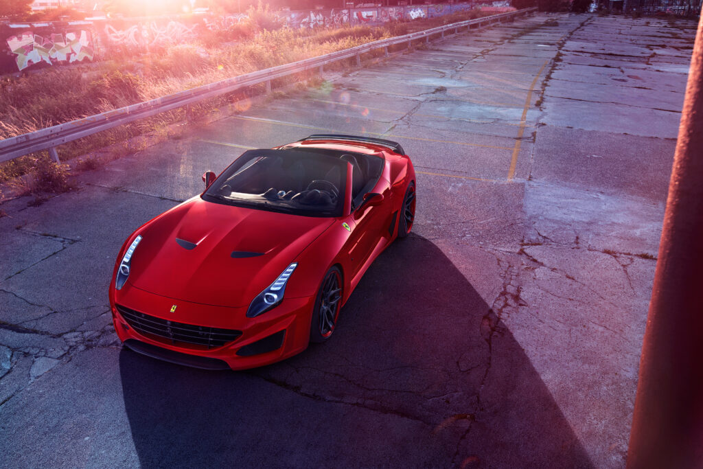 Stunning Red Ferrari Convertible on Abandoned Lot at Sunset Wallpaper