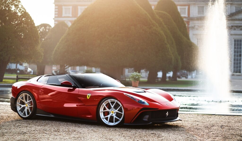 Red Ferrari F12 TRS: Stunning Side View Against Picturesque Background Wallpaper