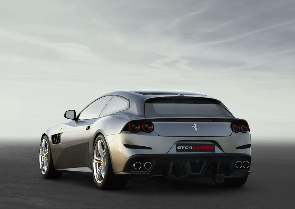 Gray Ferrari GTC4Lusso: Graceful Power Amidst Majestic Surroundings Wallpaper