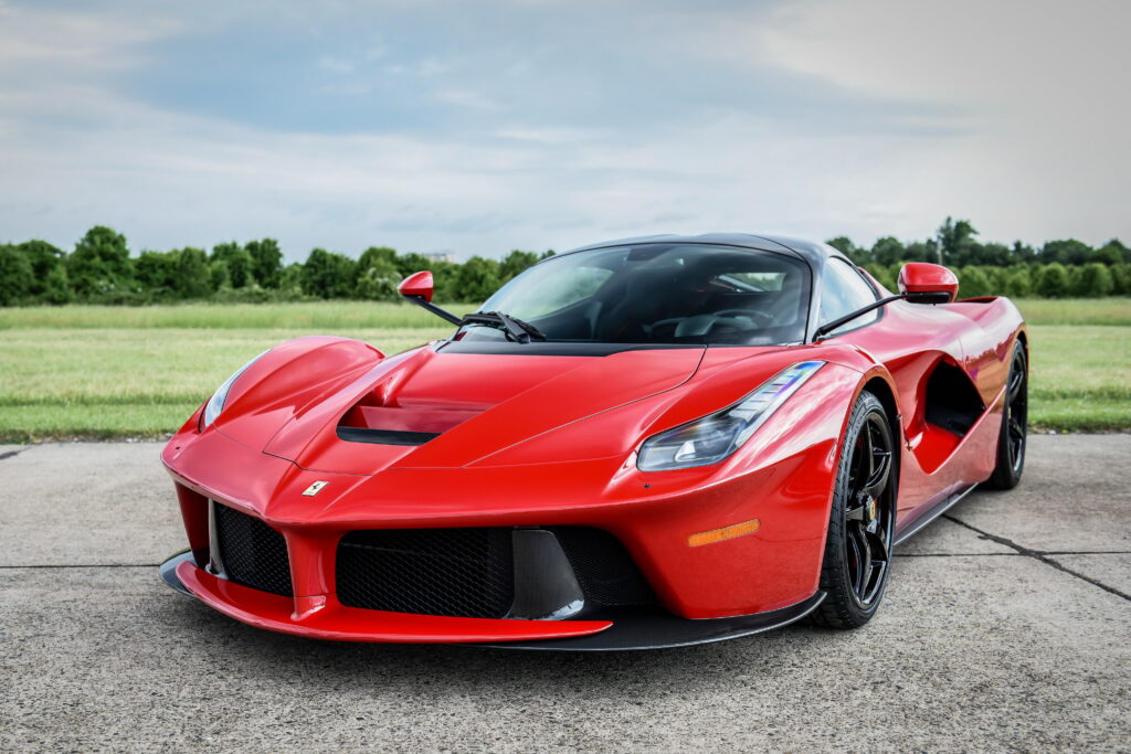 Red Ferrari LaFerrari Wallpaper: Sleek Design in Greenery