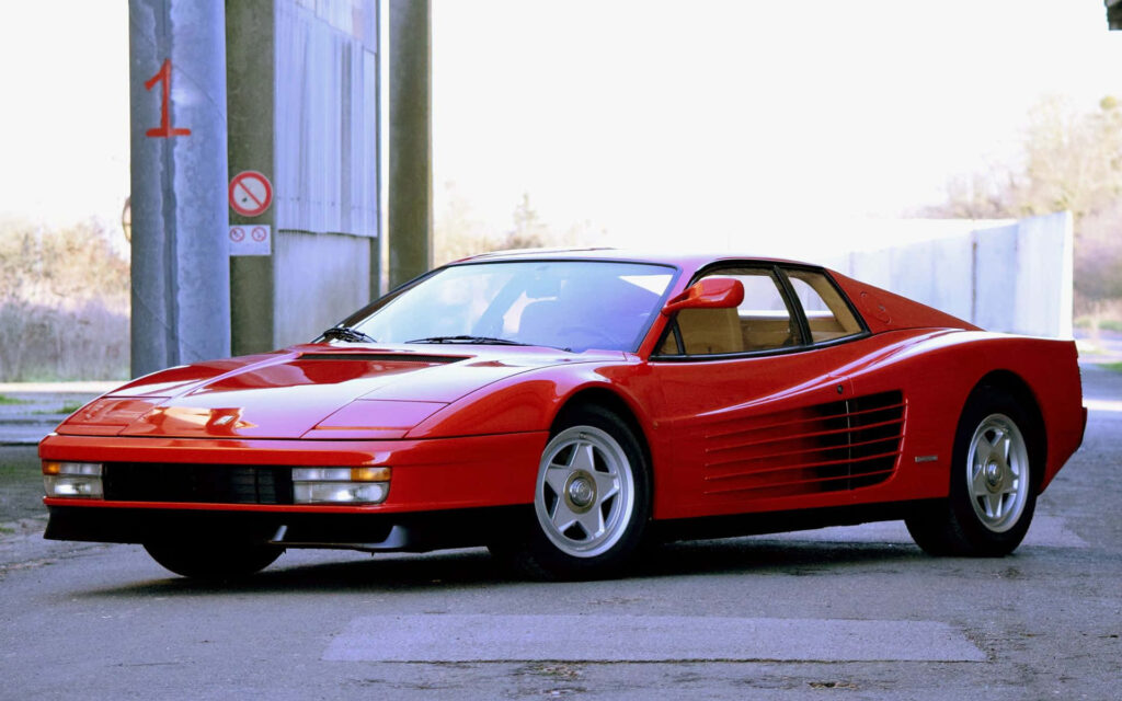 The Captivating Red Ferrari Testarossa: A Masterpiece of Design Amidst Nature's Scenic Splendor Wallpaper