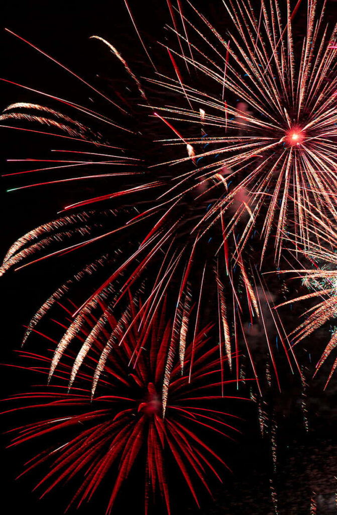 Red Delight: Captivating Fireworks Show on a Dark Canvas Wallpaper