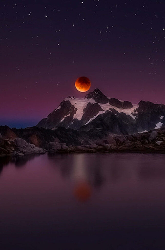 Red Full Moon Over Snowy Mountains: Stunning Night Sky Wallpaper