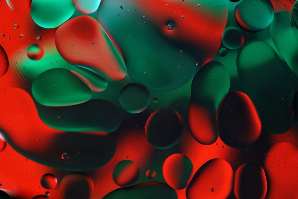 Vibrant Red and Green Abstract Wallpaper with Fluid Shapes and Bubbles
