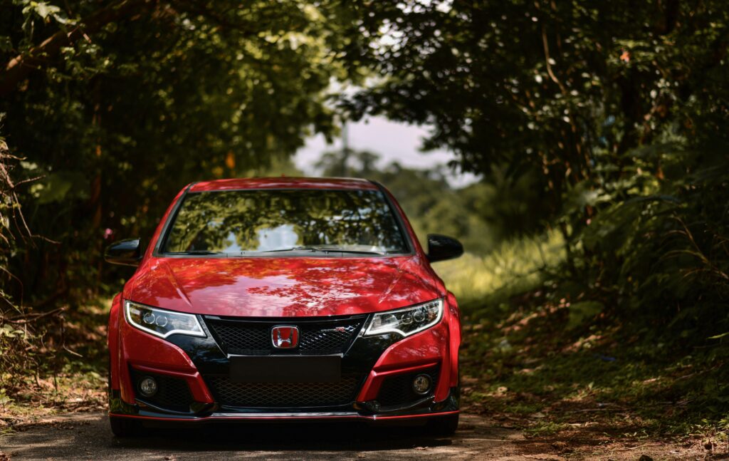 Stunning Red Honda FK2 Type R Front View with Lush Green Background Wallpaper