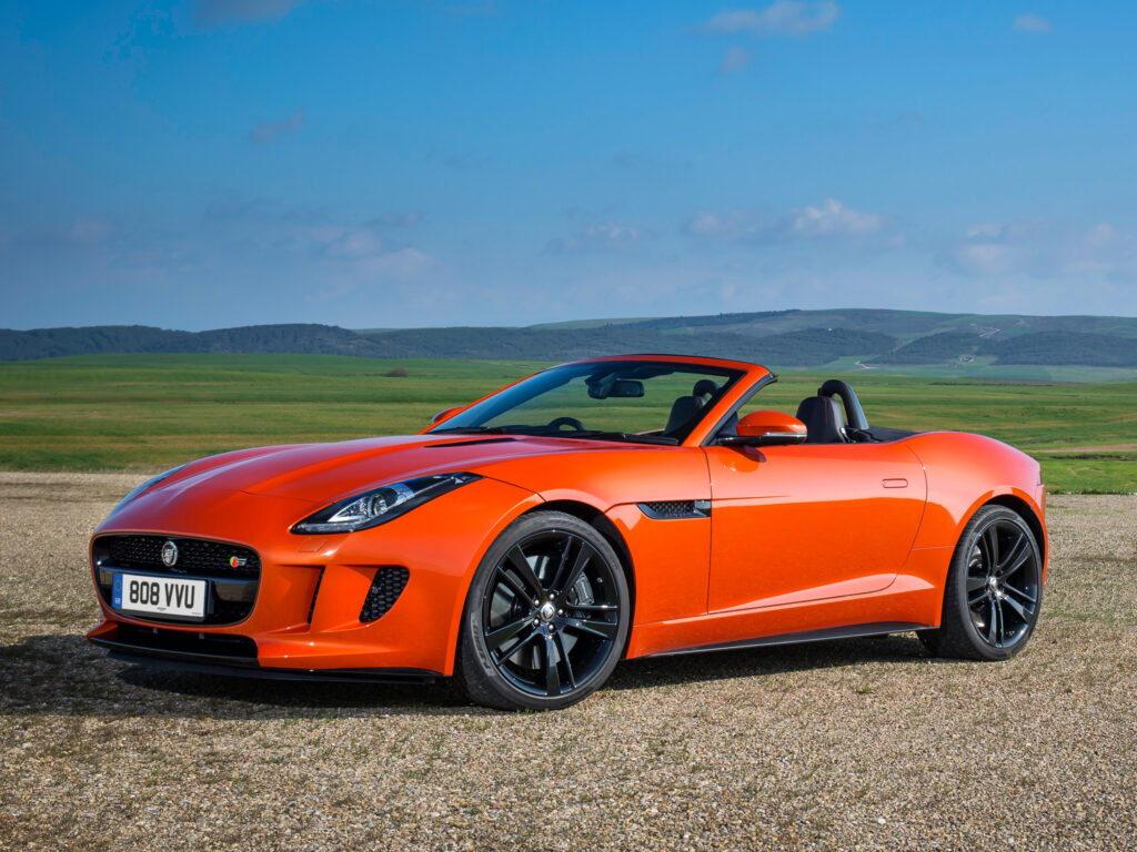 Stunning Red Jaguar F-Type V8 S Convertible in Scenic Landscape Wallpaper