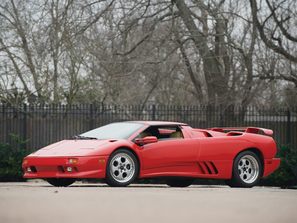 Stunning Red Lamborghini Countach Wallpaper with Bare Trees Background