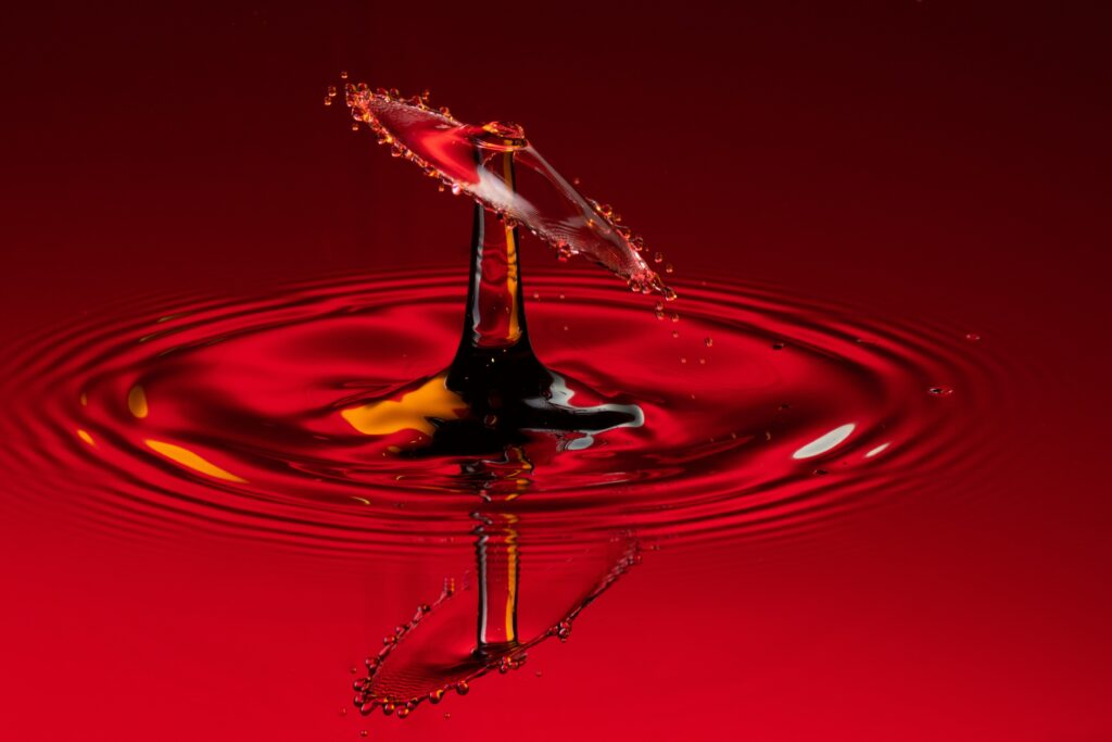Vibrant Red Liquid Drop Splash: Macro Beauty Wallpaper Background