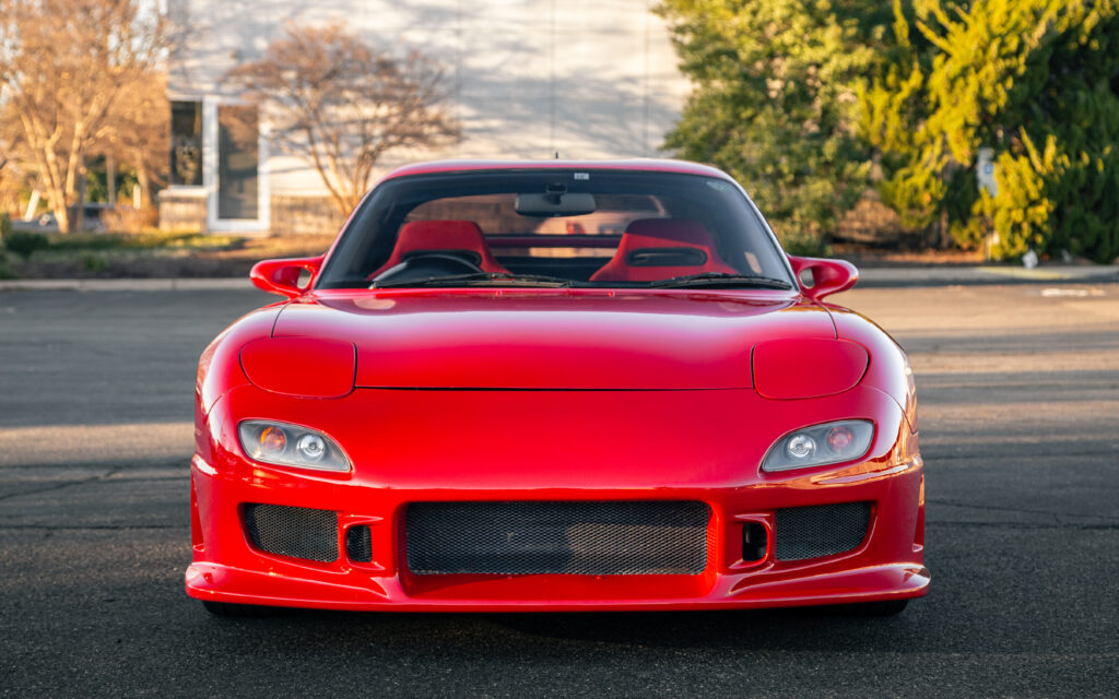 Sleek Red Mazda RX-7 Front View in Stunning Outdoor Background Wallpaper