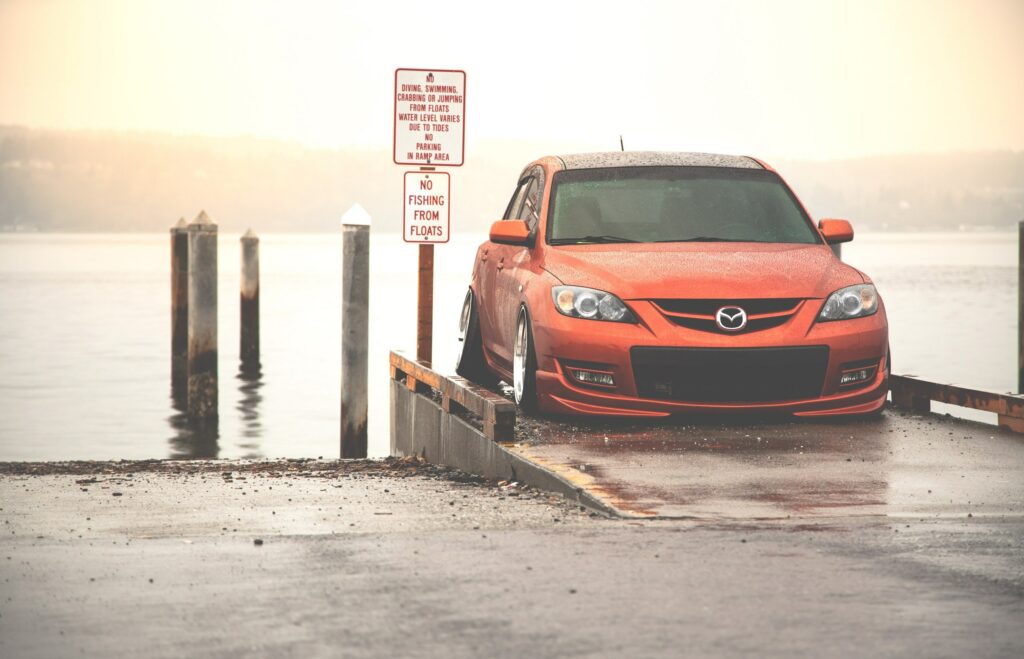 Stunning Red Mazda Front View Wallpaper by Water Under Misty Light