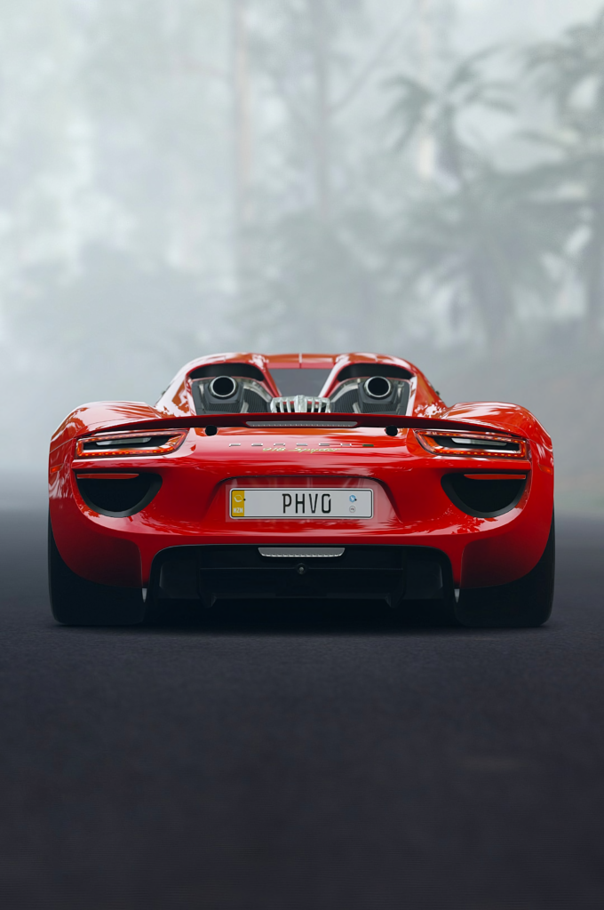 Stunning Red Porsche 918 Wallpaper: Sleek Sports Car in Nature