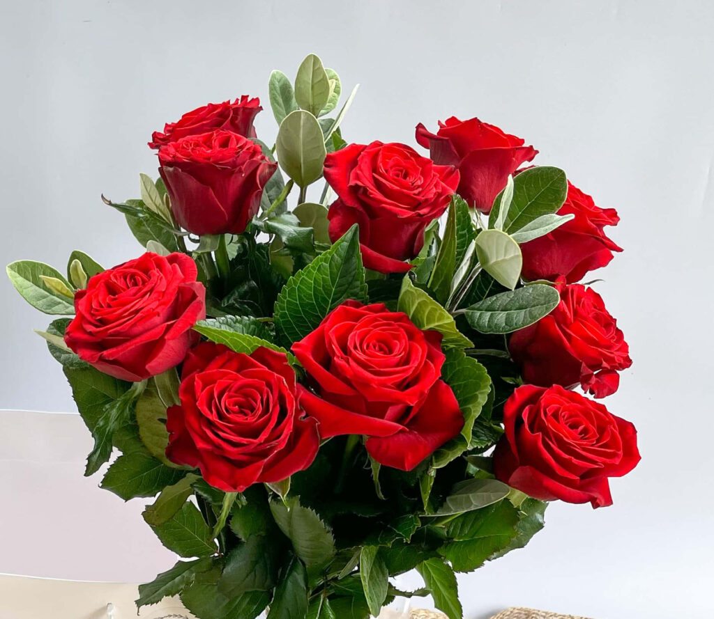Elegant Red Rose Bouquet Wallpaper with Lush Green Background