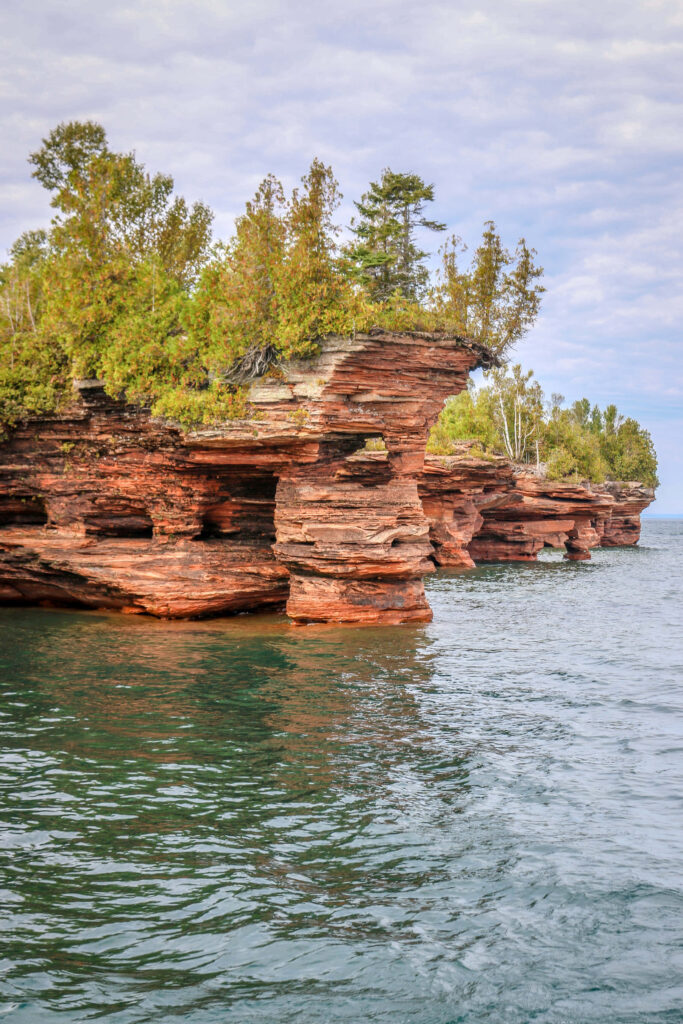 Stunning Red Sandstone Cliffs Over Serene Blue Lake - Nature Background Wallpaper