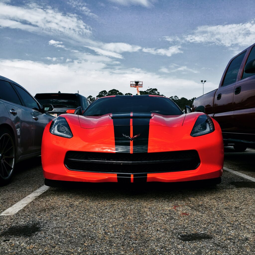 Stunning Red Sports Car Wallpaper Against Clear Sky Background