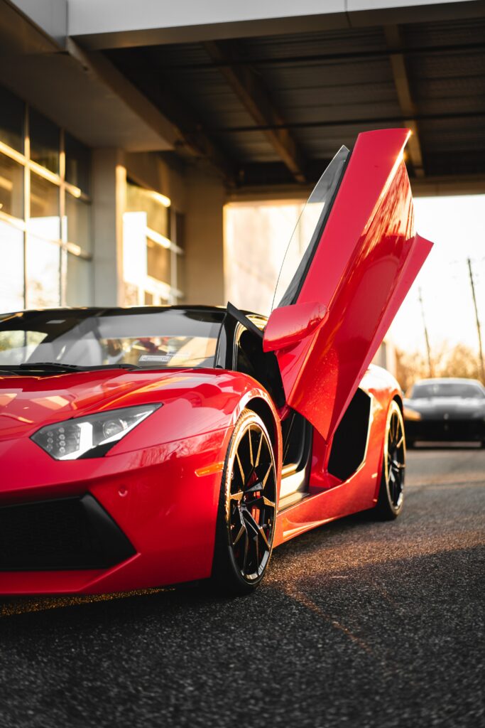 Stunning Red Sports Car Wallpaper: Sleek Design & Sunlit Finish