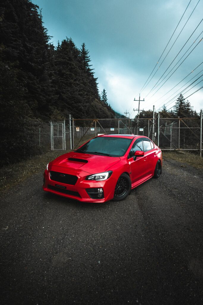 Striking Red Subaru Impreza on Rugged Gravel Path - Adventure Awaits Wallpaper