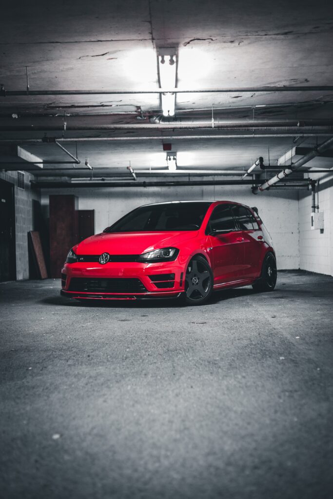 Red Volkswagen Car in Dimly Lit Garage - Modern Wallpaper