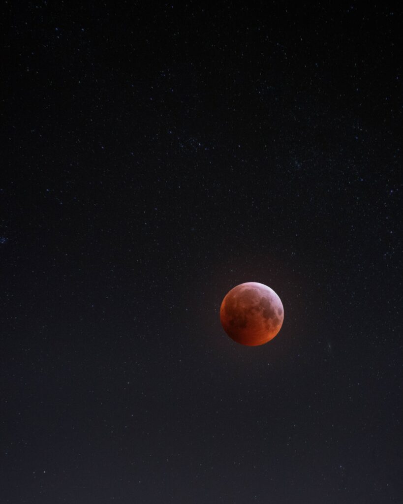 Stunning Full Moon Wallpaper: Reddish Hue & Starry Space Background