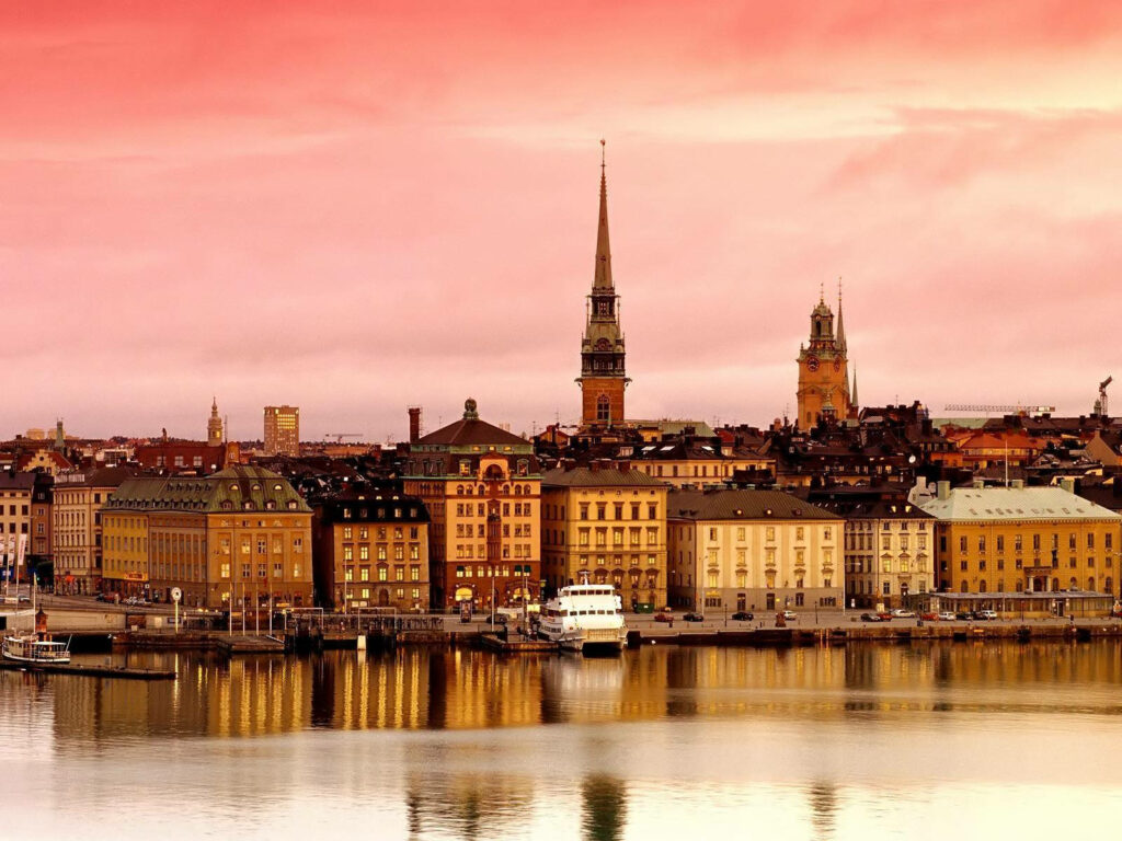 Islet of Riddarholmen: Historic Architecture & Sunset Reflection Wallpaper