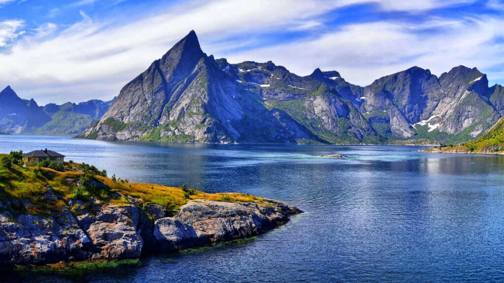 Stunning Rocky Mountains Wallpaper Over Serene Water & Lush Greenery