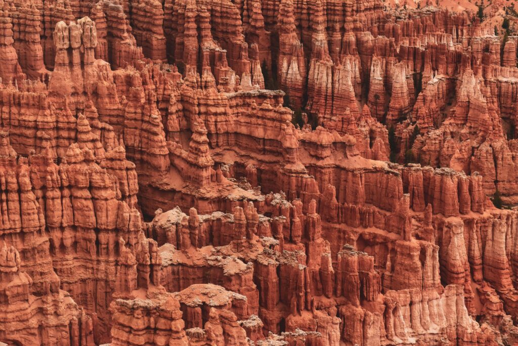 Breathtaking rugged rock relief with intricate layers in warm sandy tones natural landscape wallpaper