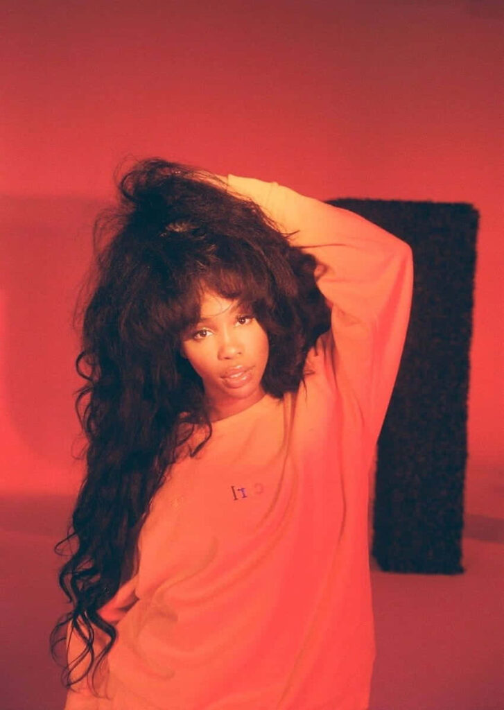 Vibrant SZA Portrait Wallpaper: Effortless Style in Red Glow