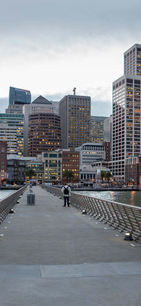 Scenic San Francisco Wallpaper: Person on Bridge with Skyline Background