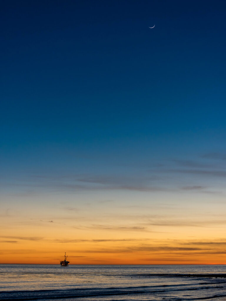 Serene Sea Sunset Wallpaper with Crescent Moon & Unique Structure
