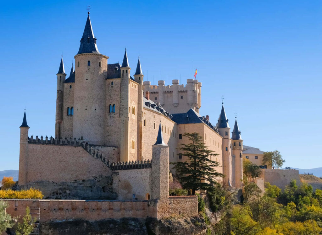 Stunning Segovia Castle Wallpaper: Iconic Towers & Lush Greens