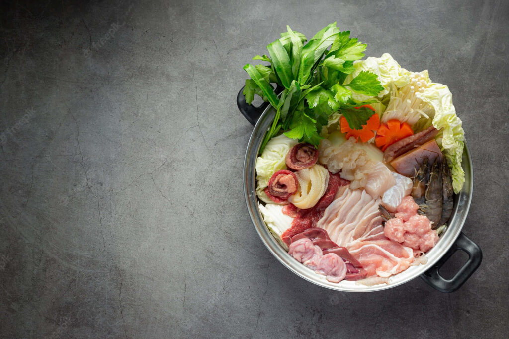 Stunning Overhead Shabu-Shabu Pot with Fresh Ingredients Wallpaper