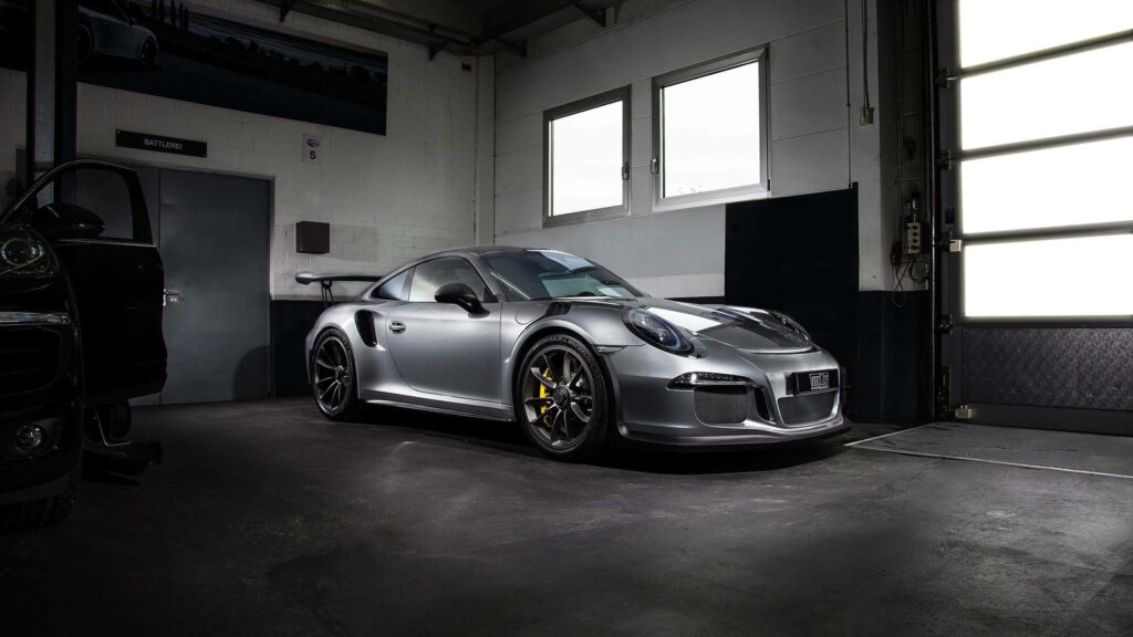 Shimmering Style: Silver Porsche 911 and Black Car in Garage Wallpaper