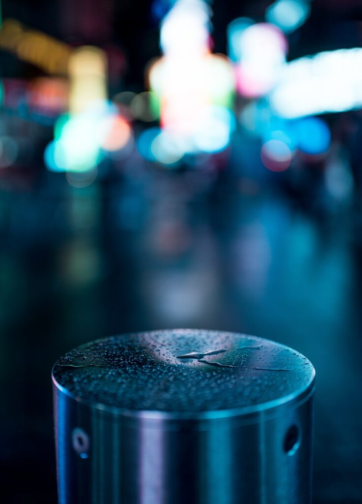Silver Round Object with Water Droplets - Colorful Cityscape Wallpaper