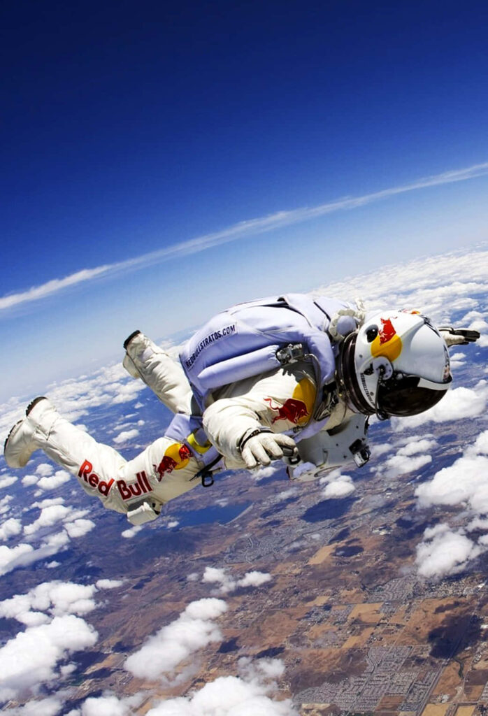 Daredevil Skydiver Wallpaper Over Snowy Landscape & Blue Sky