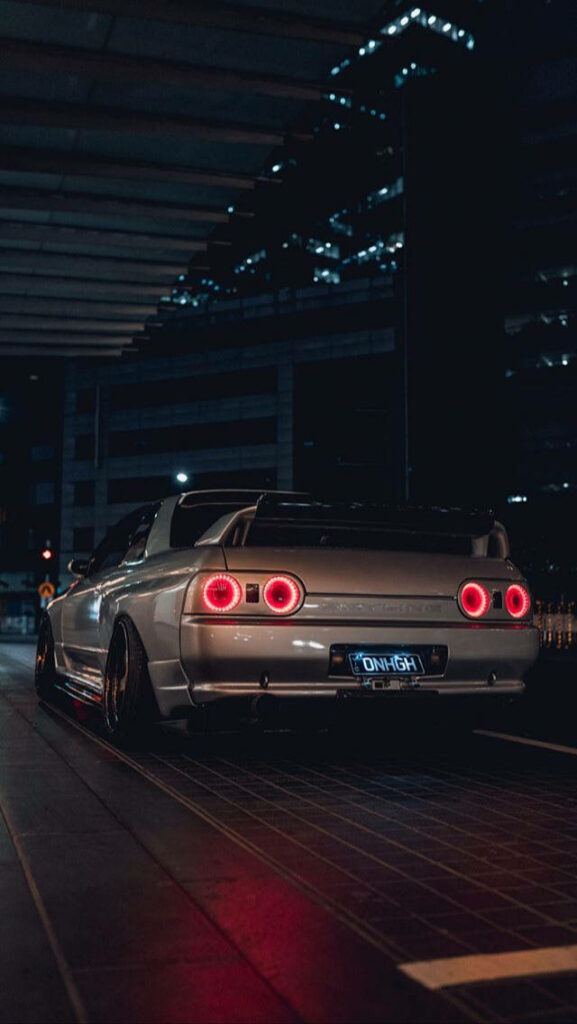 Iconic Skyline R32: Nighttime Urban Wallpaper with City Lights