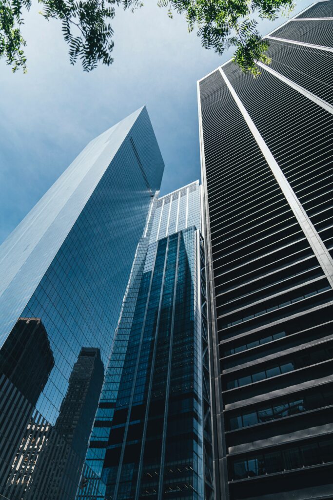 Stunning Skyscraper Wallpaper: Blue Sky & Greenery Framed View
