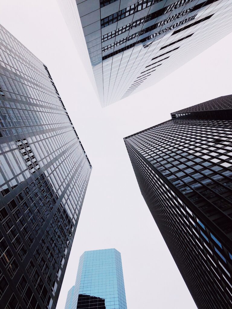 Modern Skyscraper Wallpaper: Sleek Architecture Against a Muted Sky