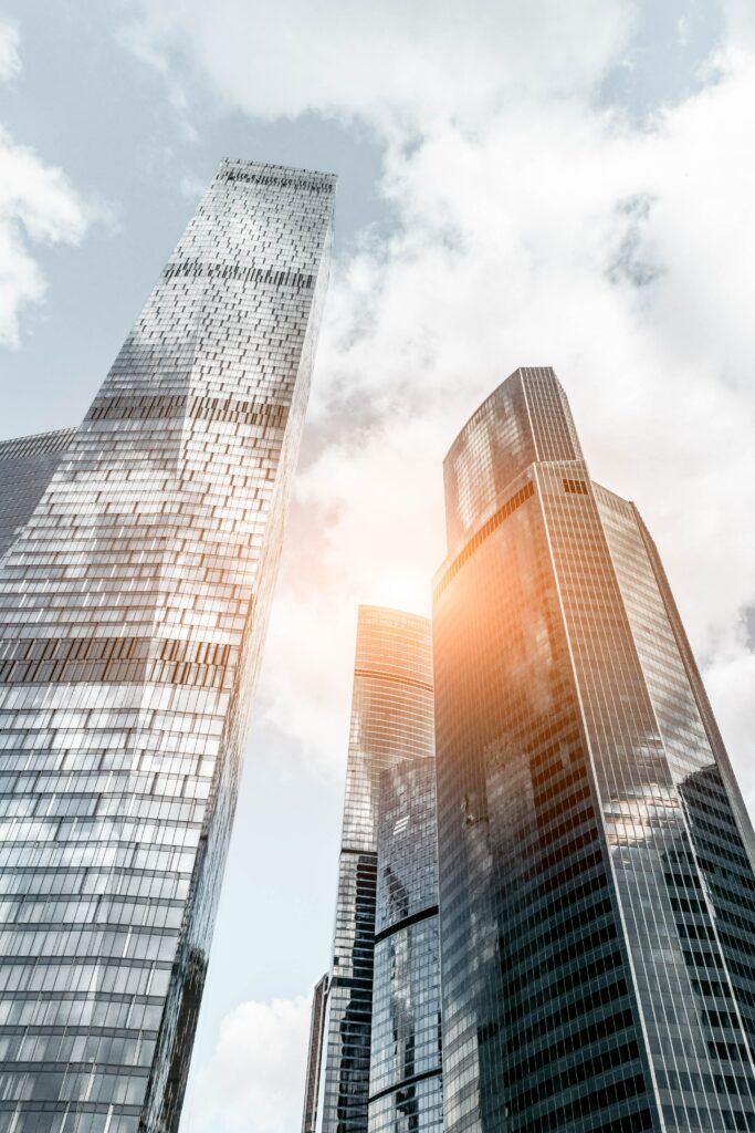 Modern Skyscrapers Wallpaper: Sleek Architecture & Sunlit Clouds