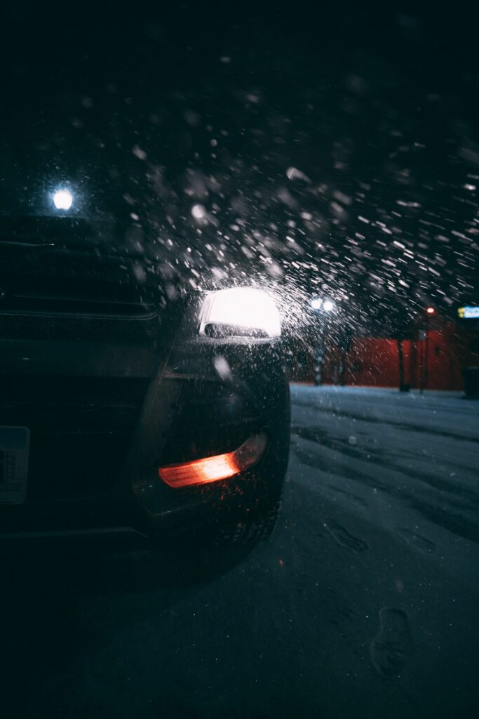 Stunning Snowy Night Car Wallpaper: Dramatic Rear View Illumination