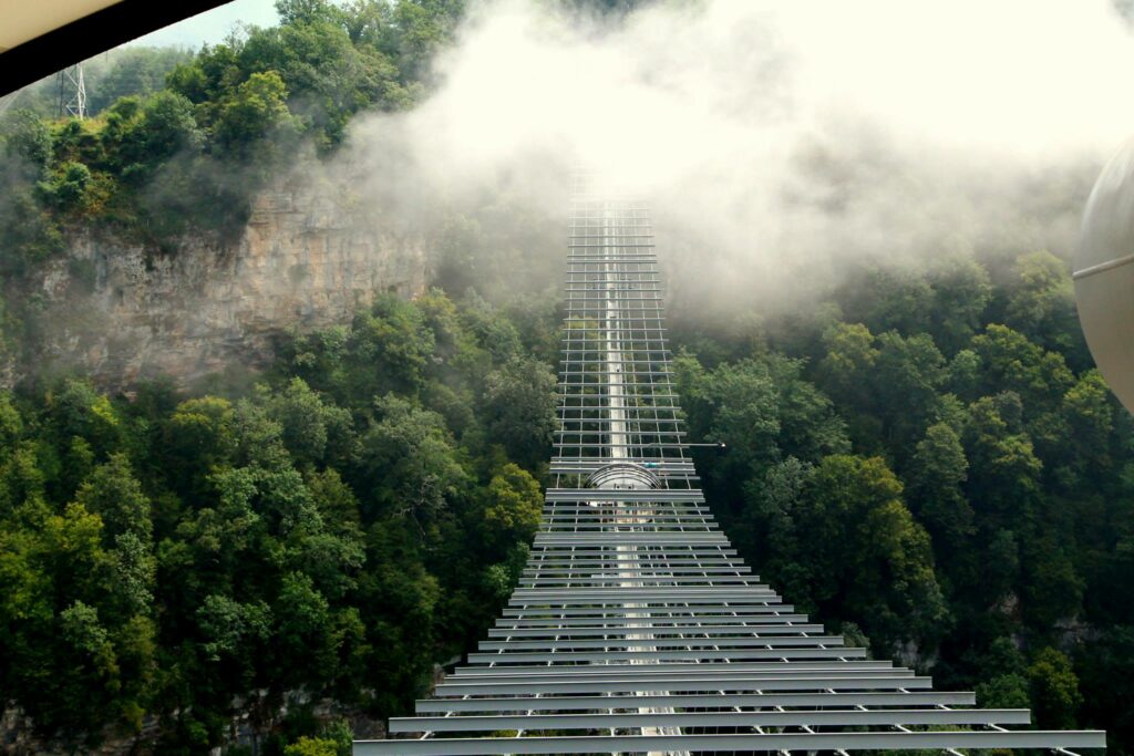Scenic Sochi Skybridge Wallpaper: Lush Greenery & Misty Vibes