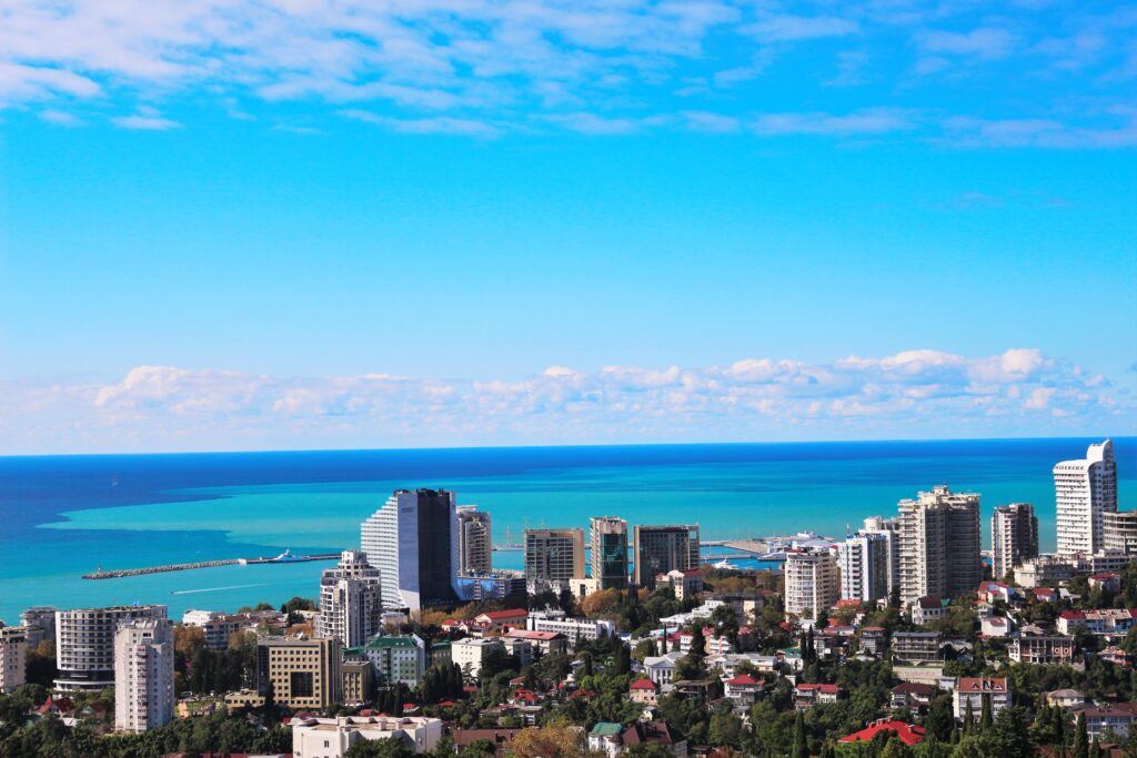 Stunning Sochi Wallpaper: Lush Arboretum Meets Urban Skyline