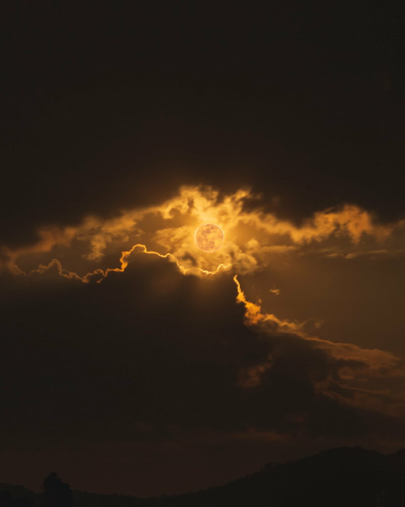 Stunning Solar Eclipse HD Wallpaper: Dark Clouds & Sun Rays Background
