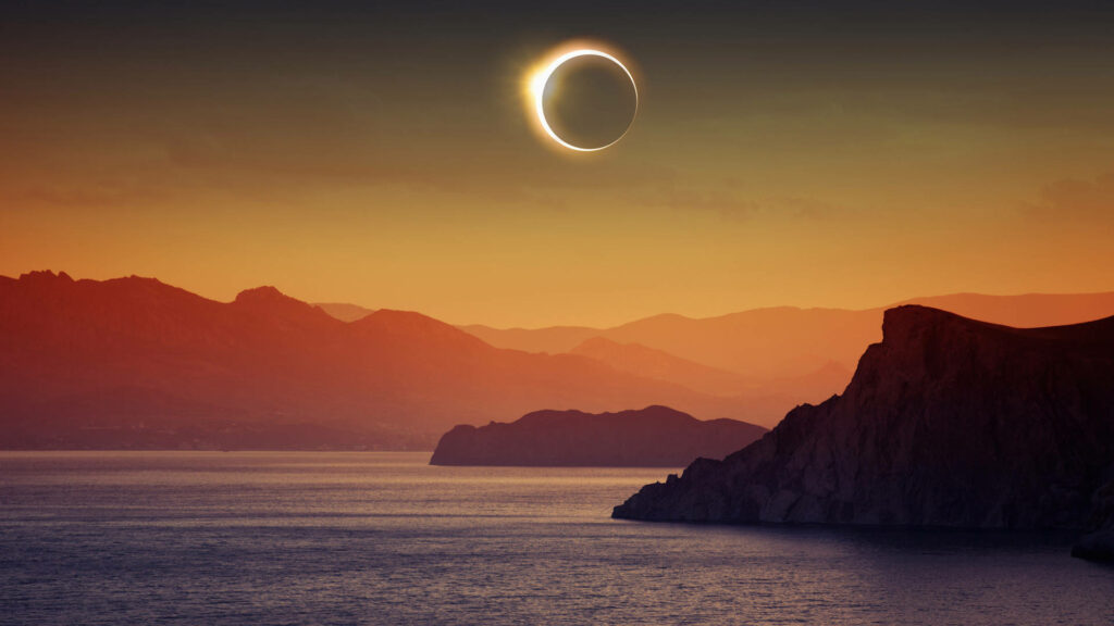 Stunning Solar Eclipse Wallpaper: Serene Seaside Cliff & Ocean