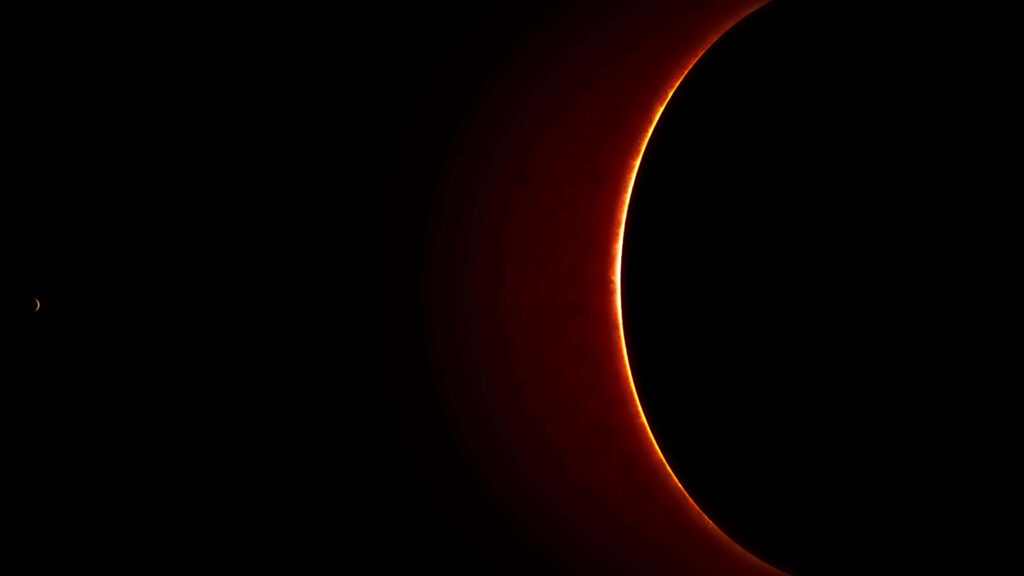 Stunning solar eclipse wallpaper featuring a glowing red ring around the dark sun on a sleek black background.