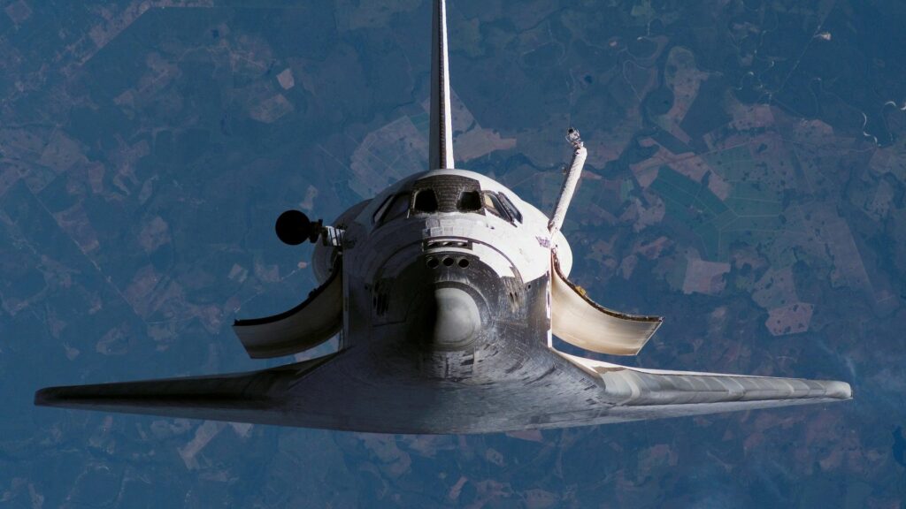 Stunning Space Shuttle Wallpaper: Flight Above Earth in Vast Space