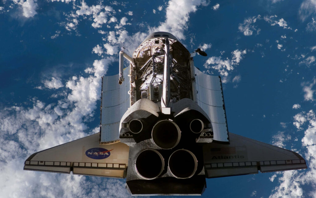 Space Shuttle in Flight: Stunning Wallpaper Background with Earth