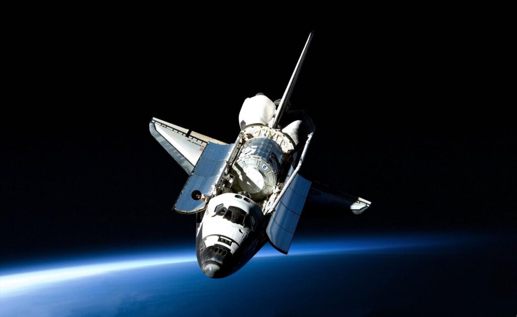 Space Shuttle Orbiting Earth: Stunning Wallpaper Background