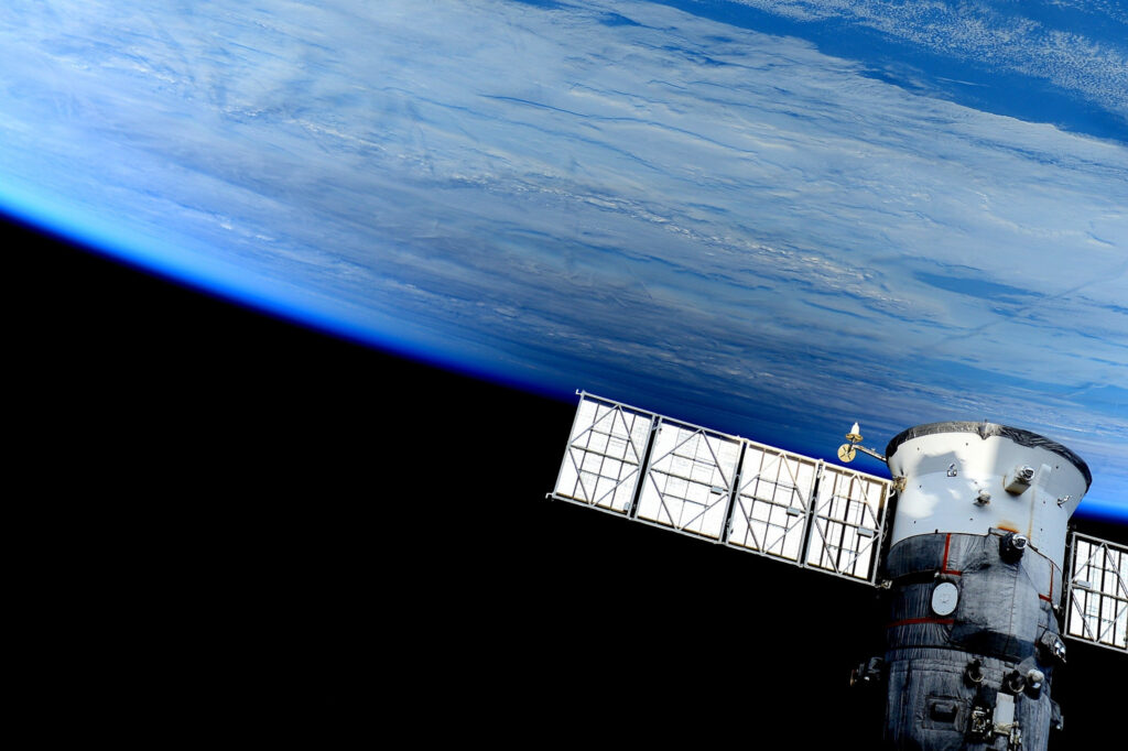 Stunning Spaceship Wallpaper: Earth View in Vibrant Outer Space