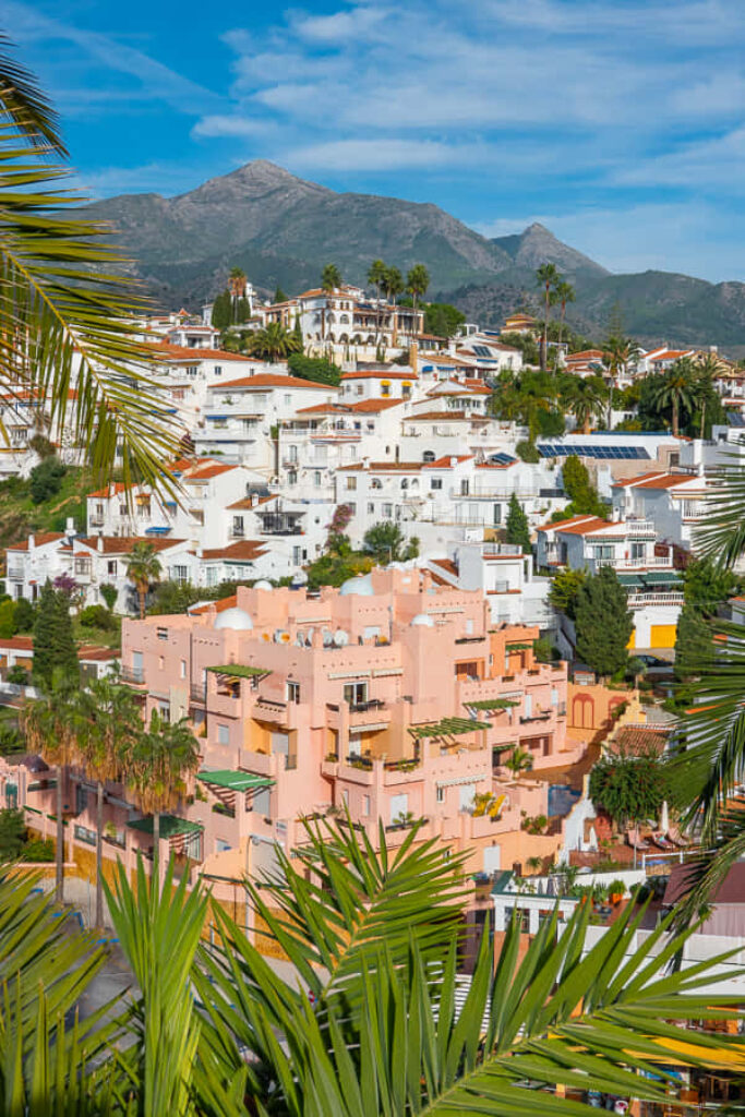 Stunning Wallpaper: Spanish Hillside Town with Whitewashed Homes & Mountains