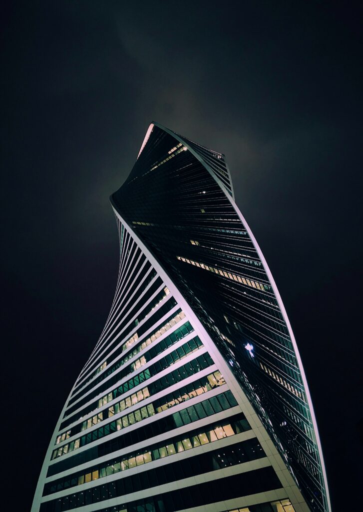 Modern Spiral Building Wallpaper: Intricate Design & Dramatic Sky